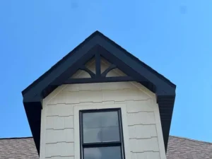 Close-up of freshly painted gable with dark trim and cream siding on a St. Louis home, professionally finished by Malone Painting exterior painters.