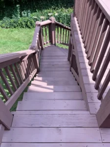 Freshly Stained wooden deck stairs with protective brown finish, restored by Malone Painting exterior wood and deck services in St. Louis.