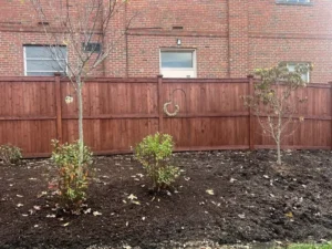 Wooden fence with a new dark stain.