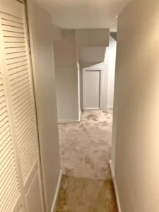 Updated basement hallway with freshly painted neutral walls and white trim in a St. Louis home by Malone Painting. Professional interior painting makes small spaces brighter, cleaner, and more inviting.