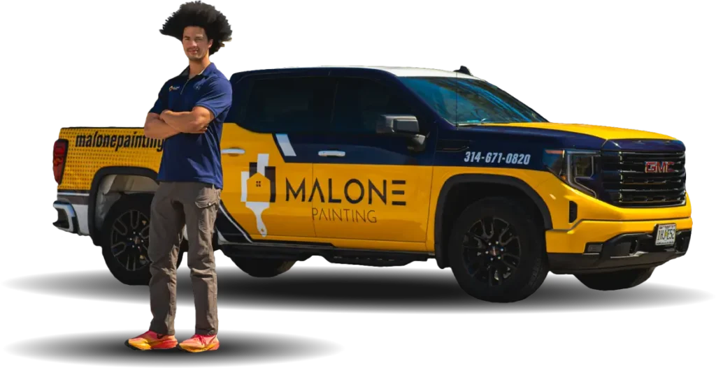 A man named Jaren, the sales rep, with an afro hair, wearing a Malone Painting polo shirt, dark pants, and red sneakers, stands with his arms crossed next to a branded yellow and blue Malone Painting truck. The background is transparent
