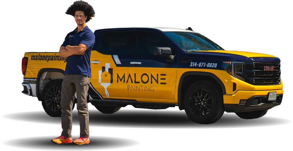A man named Jaren, the sales rep, with an afro hair, wearing a Malone Painting polo shirt, dark pants, and red sneakers, stands with his arms crossed next to a branded yellow and blue Malone Painting truck. The background is transparent