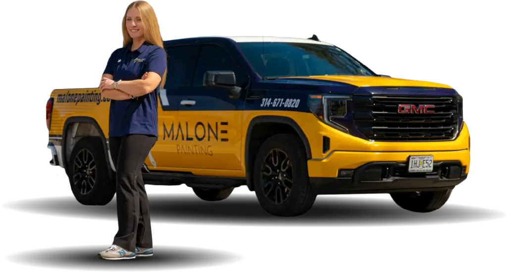 A woman named Jen, the office manager of Malone Painting, with long hair, wearing a Malone Painting polo shirt and dark pants, stands with her arms crossed next to a branded yellow and blue Malone Painting truck. The background is transparent