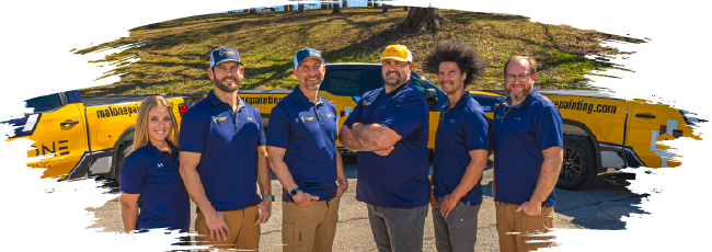 Malone Painting team standing in front of company trucks, smiling and wearing branded polo shirts